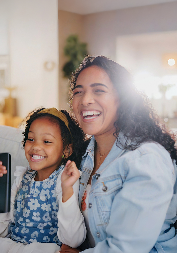 A young family laughing together at home